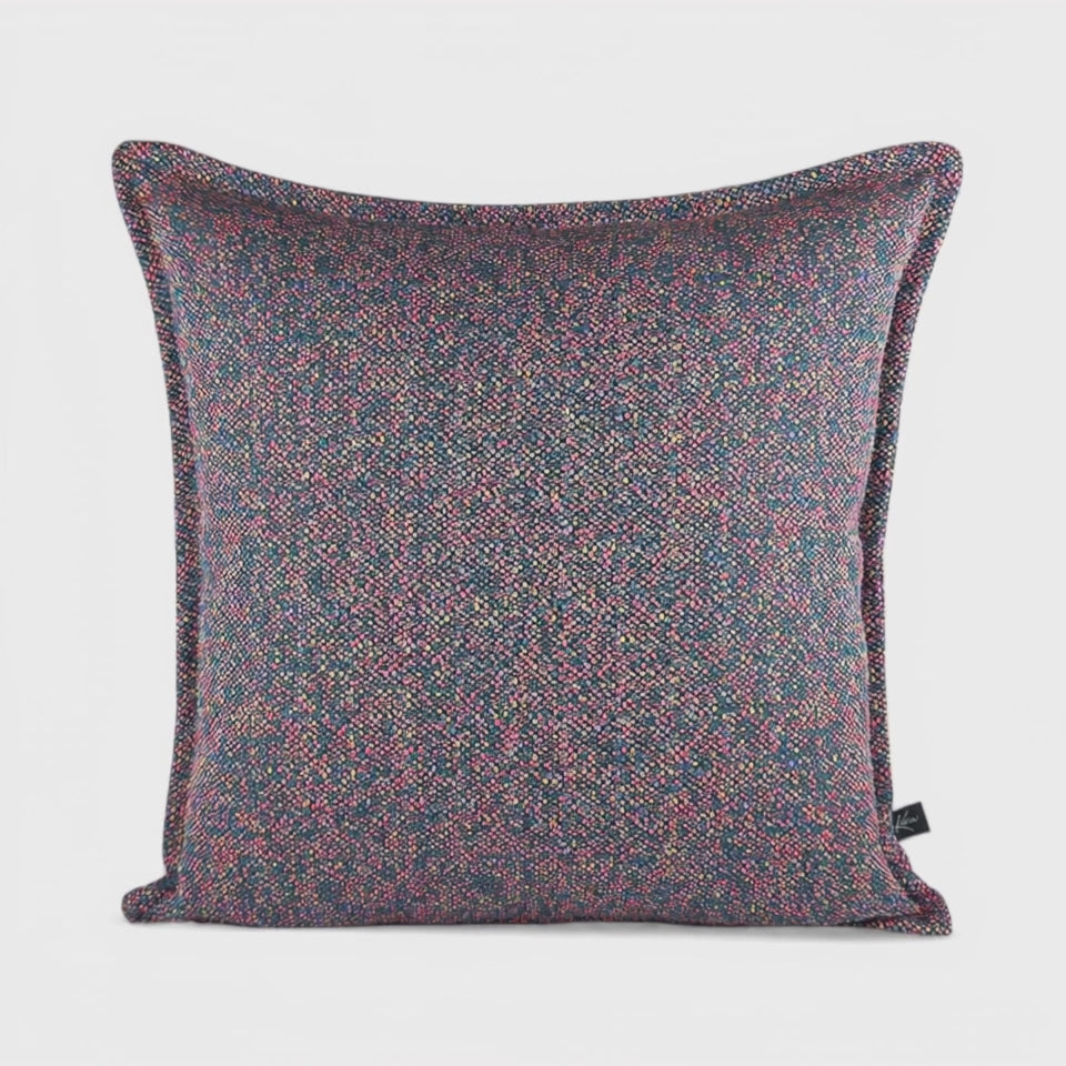 Cushion KULURI 50x50 in shades of purple with a colorful pattern and palette.